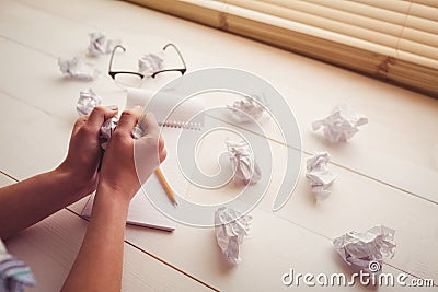 Hands crumpling paper on wooden desk Stock Photo