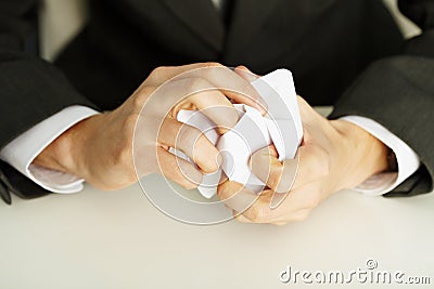 Hands crumpling a white paper Stock Photo