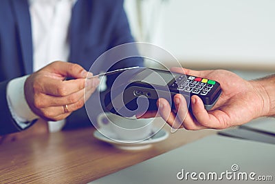 Hands of customer paying restaurant bill using credit card Stock Photo