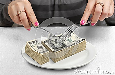 Hands Cut money on plate, reduce funds concept Stock Photo