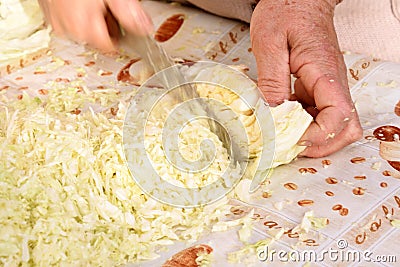 Hands cutting cabbage Stock Photo