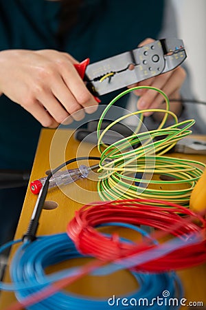 hands cutting cable with pliers Stock Photo