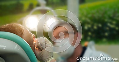 Hands dentist examines the patient Stock Photo