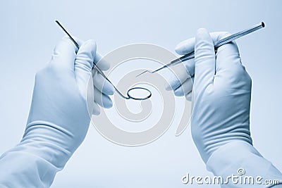 Hands of dentist holding his tools Stock Photo