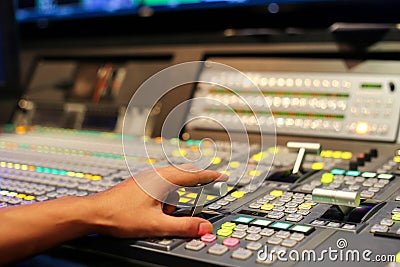 Hands on dissolve of Switcher buttons in studio TV station, Audi Stock Photo