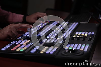 Hands on dissolve of Switcher buttons in studio TV station, Audio and Video Production Switcher of T Stock Photo