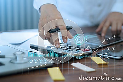 Hands of doctor doing finances and calculate on table and Healthcare business graph data and growth on hospital background Stock Photo