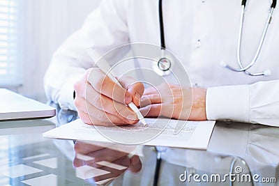 Hands of doctor writing Stock Photo