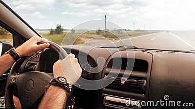 Hands driving car wheel Stock Photo