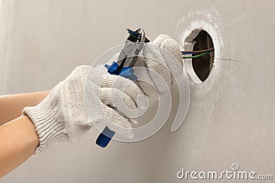 Hands of electrician cutting wires Stock Photo