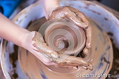 Hands of Experienced Female Potter Working with Clay. Posing with Clay Lump on Potter`s Wheel in Workshop Stock Photo