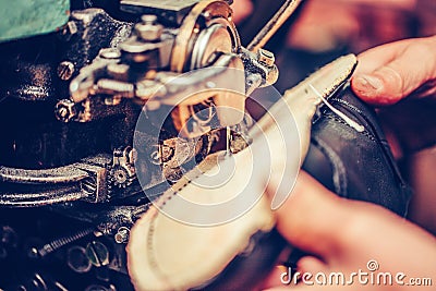 Hands of an experienced shoemaker stitching a part of the shoe Stock Photo