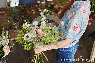 hands of florist collect wedding bouquet at work Stock Photo