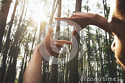 hands framing distant over view sun Stock Photo