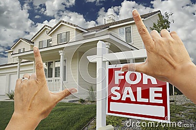 Hands Framing Real Estate Sign and New House Stock Photo