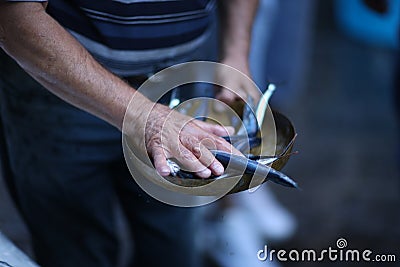 The hands of the fresh fish dealer Stock Photo