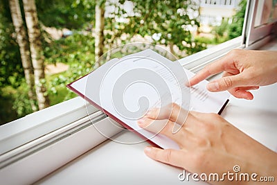 Hands of girl point book close-up. Stock Photo