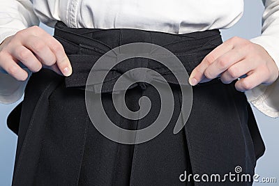 Hands of a girl tie a hakama Stock Photo