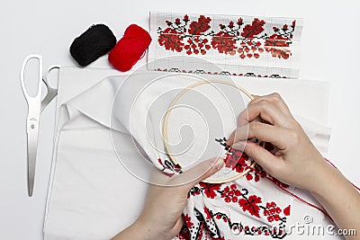 Hands girls embroider pattern using the frame. Stock Photo
