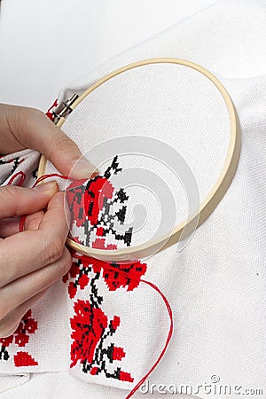 Hands girls embroider pattern using the frame. Stock Photo