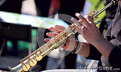 Hands on a golden flute. Musical concept. Street musician Stock Photo