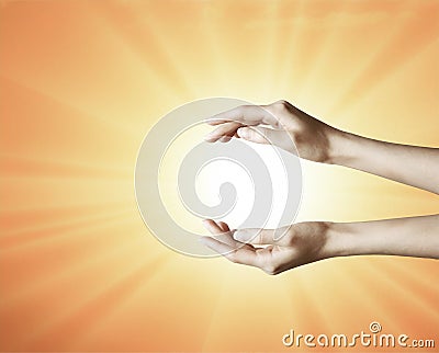 Hands grabbing the sun between, holding a dream, spark of hope, the light of faith background Stock Photo