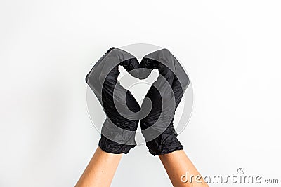 Hands heart made of black medical gloves isolated on white background Stock Photo