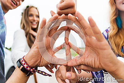 Hands of hippie friends showing peace sign Stock Photo