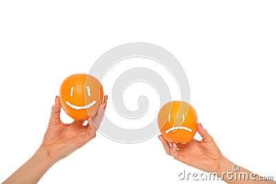 Hands hold oranges with smile and insult Stock Photo