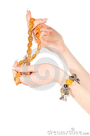 Hands holding amber necklace and bracelet Stock Photo