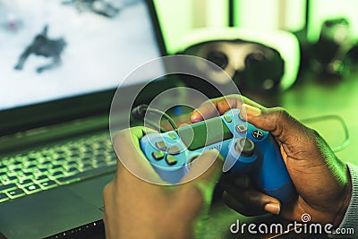 hands holding blue game pad joystick - close up shot Stock Photo