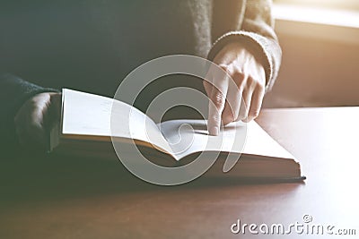 Hands holding book and reading Stock Photo