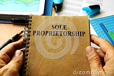 Hands holding book Sole proprietorship. Stock Photo