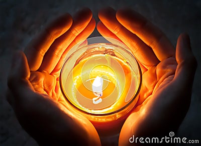 Hands holding burning candle Stock Photo