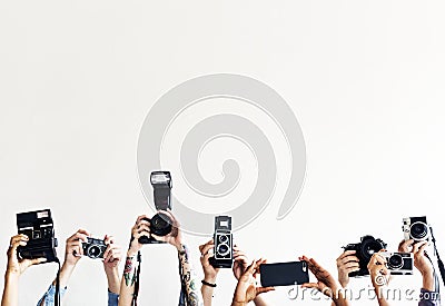 Hands are holding cameras with white background Stock Photo