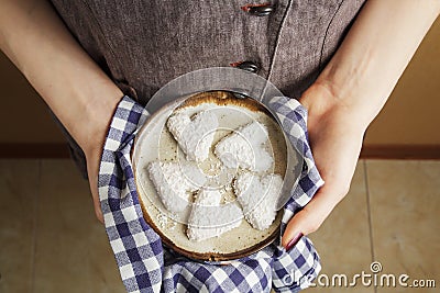 Hands holding ceramic plate with biscuits in the shape of a heart, St.Valentine`s Day concept Stock Photo