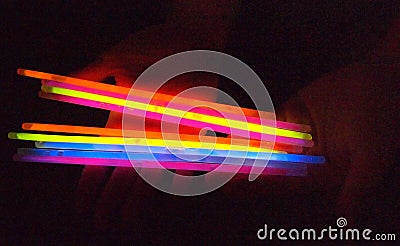 Hands holding Colourful Glow sticks Stock Photo