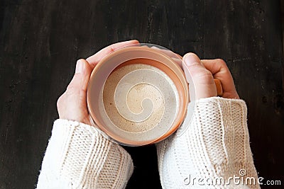 Hands Holding Cup of Coffee with Heart Shape Stock Photo