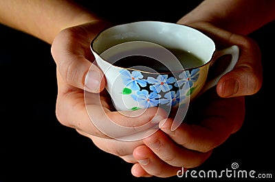 Hands Holding Cup of Tea Stock Photo