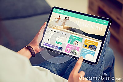 Hands holding digital tablet with application booking flight travel search ticket holiday and hotel on website discounted price, Stock Photo