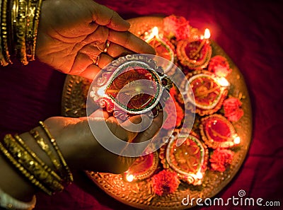 Hands holding Diwali lamps Stock Photo