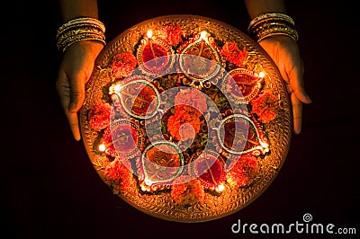 Hands holding Diwali lamps Stock Photo
