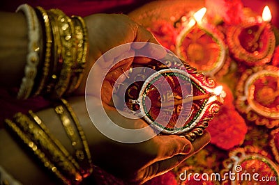 Hands holding Diwali lamps Stock Photo