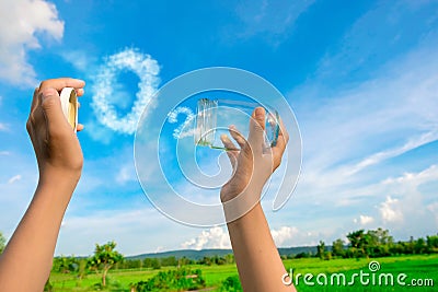 Hands holding glass jar for keeping fresh air, O2 cloud word with a blue sky in the background Stock Photo