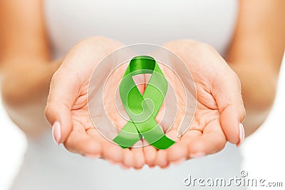 Hands holding green awareness ribbon Stock Photo