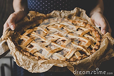 Hands holding homemade delicious apple pie. Close up Stock Photo