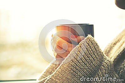 Hands holding hot cup of coffee or tea Stock Photo