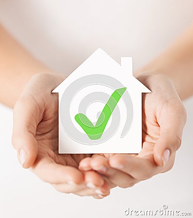 Hands holding house with check mark Stock Photo