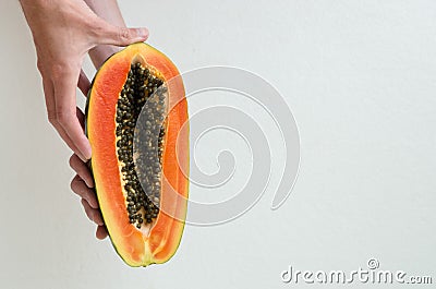 Hands holding a papaya slice. Stock Photo