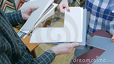 Hands holding passepartout for package picture in frame Stock Photo